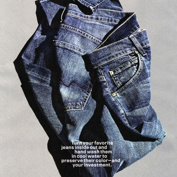 Folded blue jeans on a gray background with text about washing jeans.