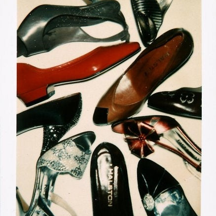 Collection of various women's shoes on a light background